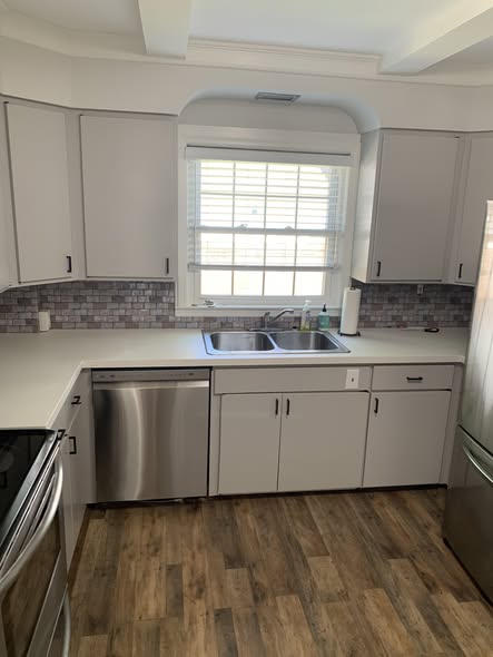 Updated kitchen with gray cabinets and luxury vinyl plank flooring