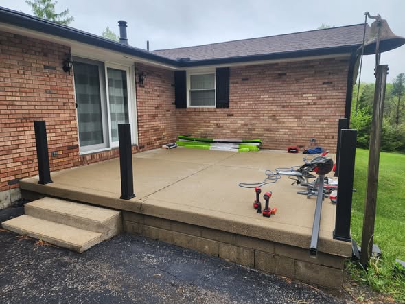 Patio build in progress with new posts and railing