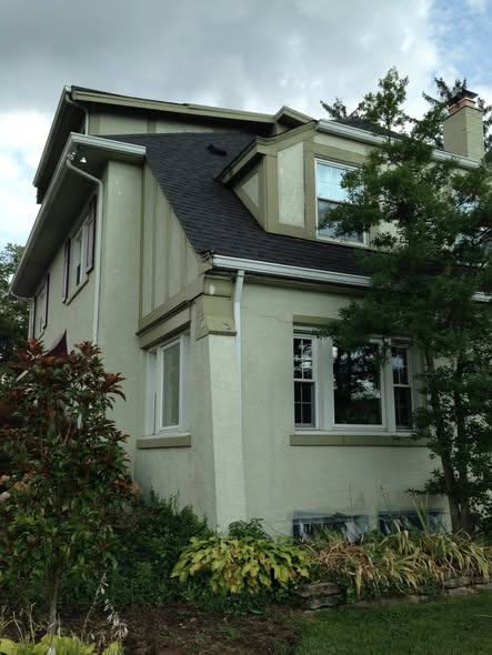 Two-story stucco home exterior repainted by Traditions